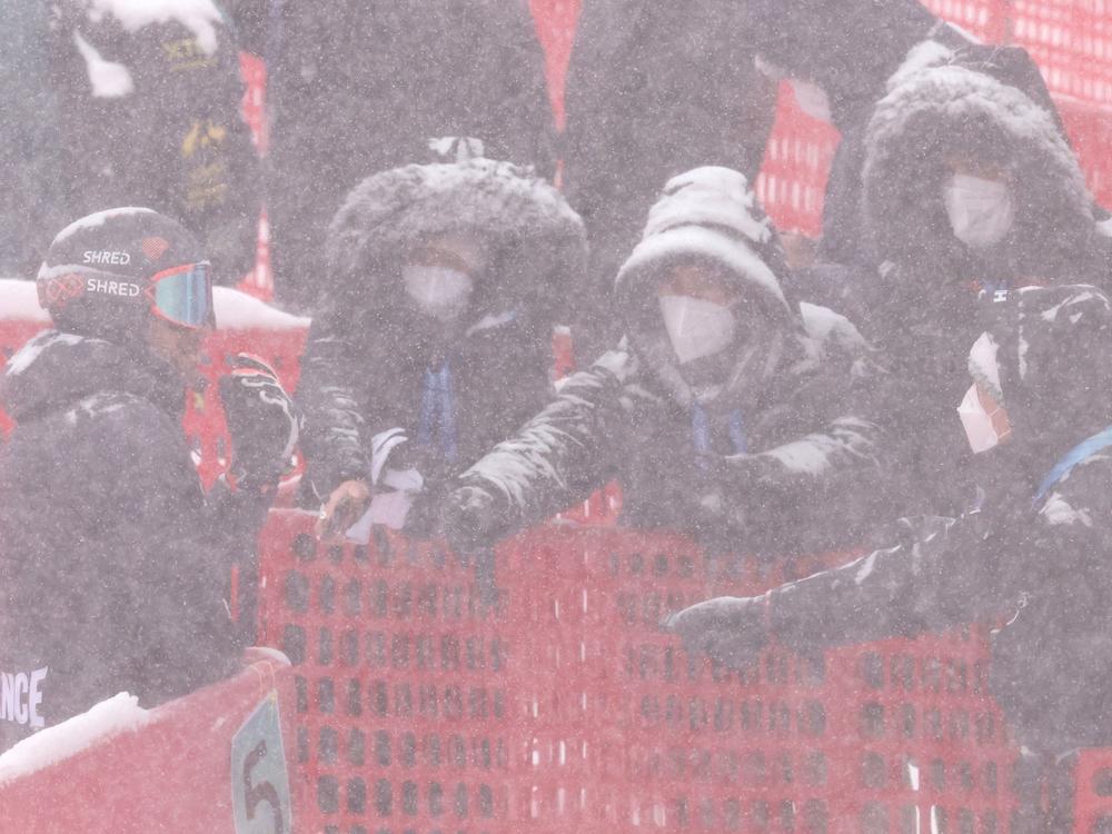 France's Mathieu Faivre (left) speaks in the mixed zone after the first run of the men's giant slalom.