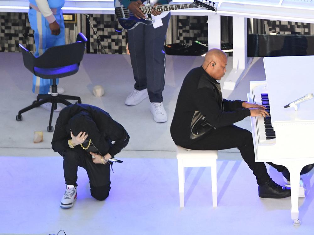 Eminem took a knee as he performs during the Super Bowl halftime show.
