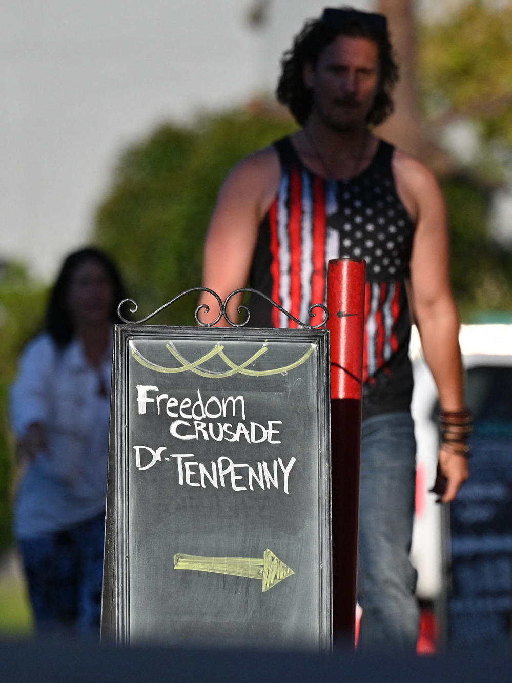 People arrive at Old World Huntington Beach where Dr. Sherri Tenpenny was scheduled to speak at the 