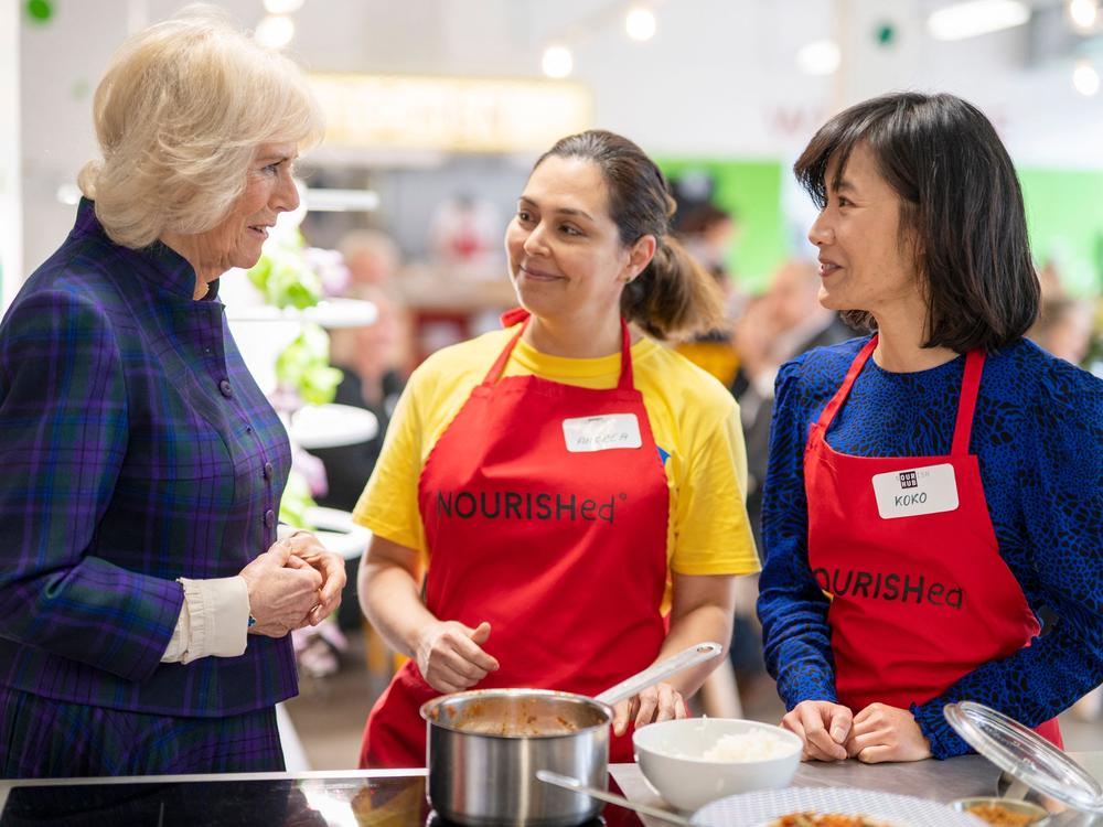 Britain's Camilla, Duchess of Cornwall speaks to members of staff as she attends the opening of the charity and community Kitchen 