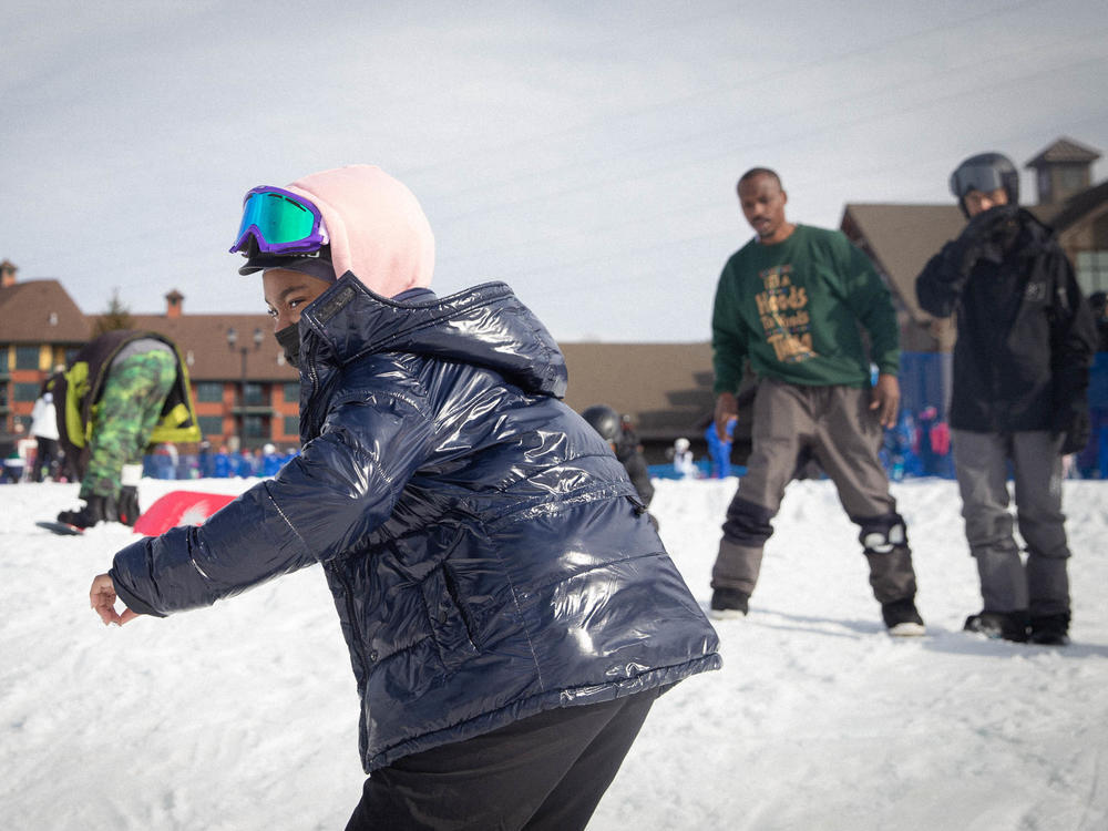 Madison Pough snowboards at Mountain Creek Resort as Diaz looks on and coaches.