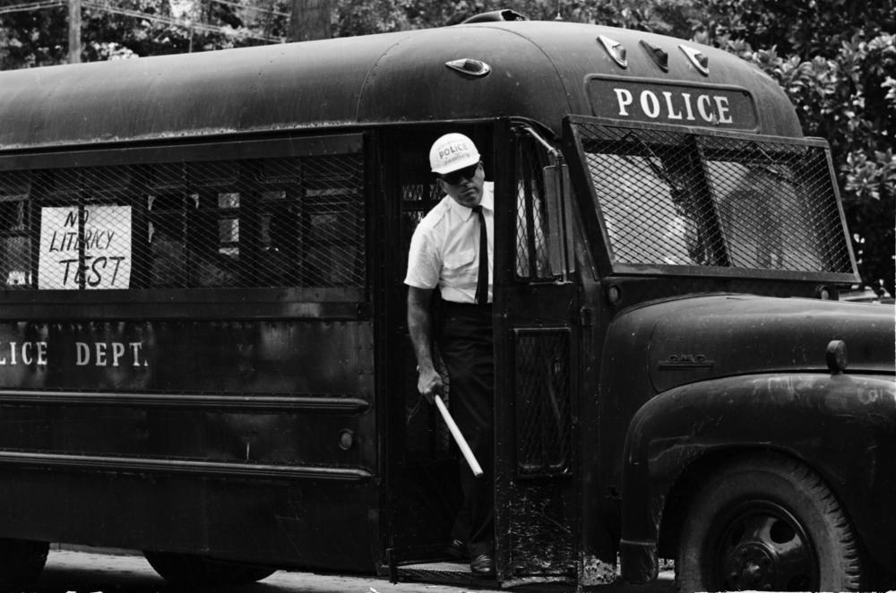 An arrest wagon awaits Freedom Day civil rights protesters in Greenwood, Miss., 1964.