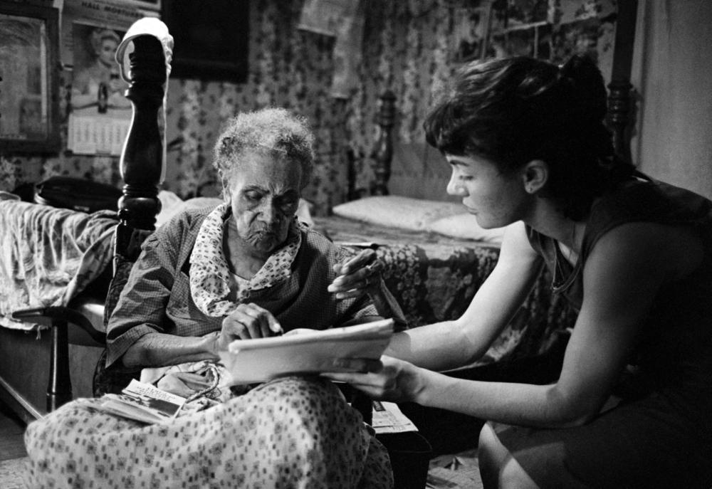 A senior citizen ponders voter registration advice from a Freedom Summer volunteer, rural Mississippi, 1964.
