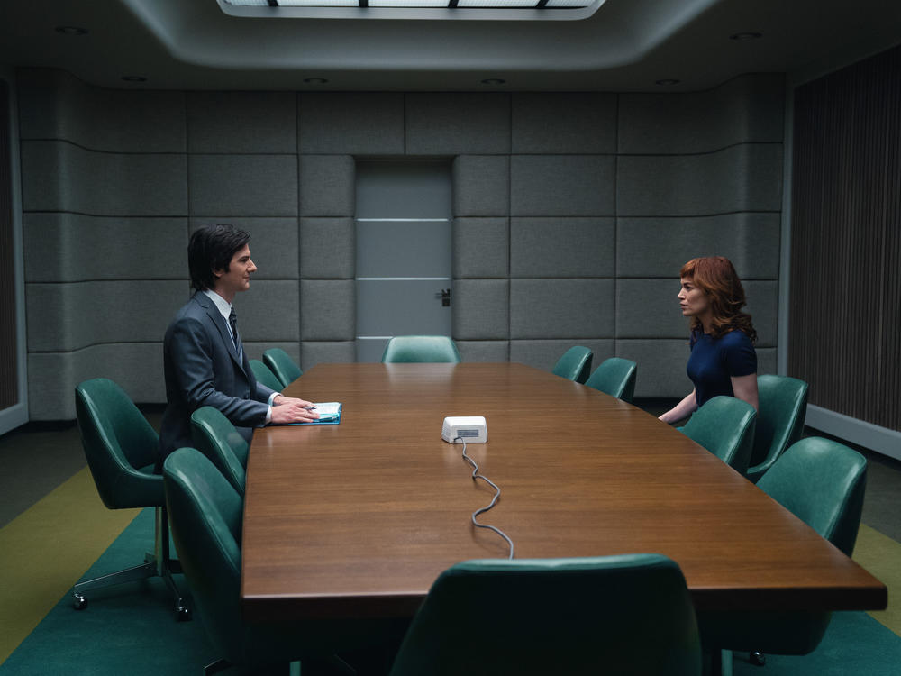 Mark (Adam Scott) greets new employee Helly (Britt Lower) in the Apple TV series <em>Severance</em>.