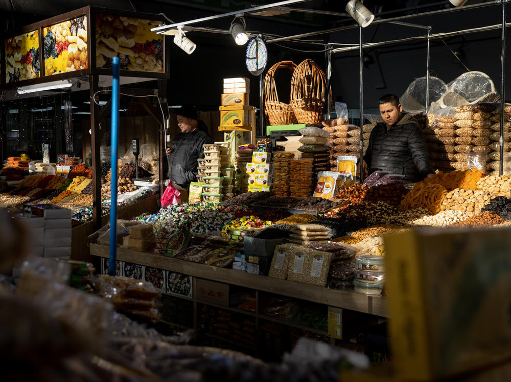 Shop owners wait for customers at a market on Tuesday in Kyiv. Though the U.S. has warned of an invasion by Russia, many Ukrainians do not share the same sense of concern that they feel Western media is creating.