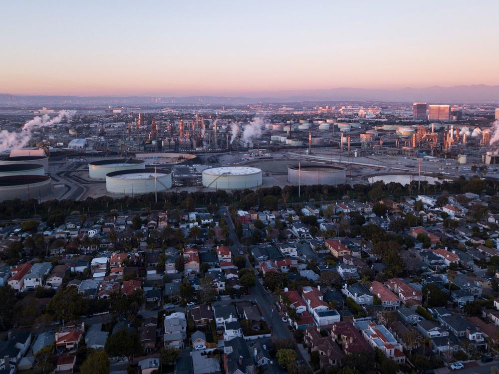 An aerial image shows storage tanks at the Chevron Products Company El Segundo Refinery adjacent to a neighborhood of homes at sunset in Manhattan Beach, Calif., on Jan. 24.