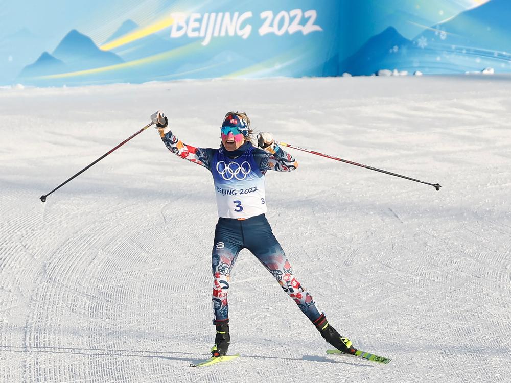 Norway's Therese Johaug gestures as she wins the women's skiathlon 2x7,5km event during the Beijing 2022 Winter Olympic Games on February 5, 2022.