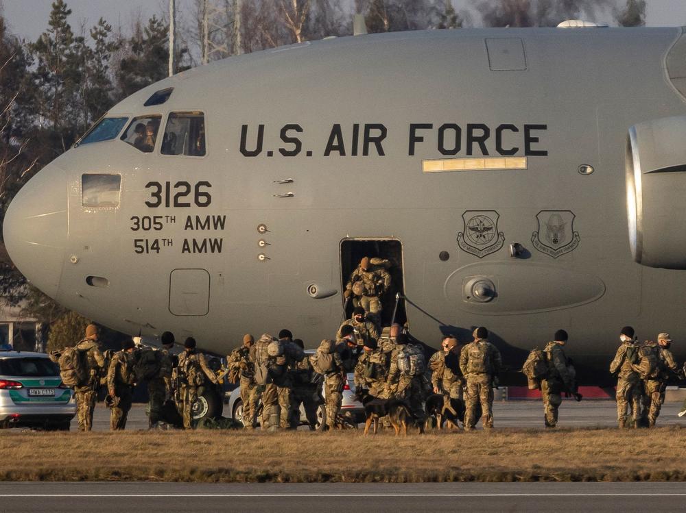 U.S. troops disembark from a C-17 plane on the tarmac of Rzeszow-Jasionka Airport in  southeastern Poland on Feb. 16, part of a deployment sent to bolster NATO's eastern flank in response to Russia.