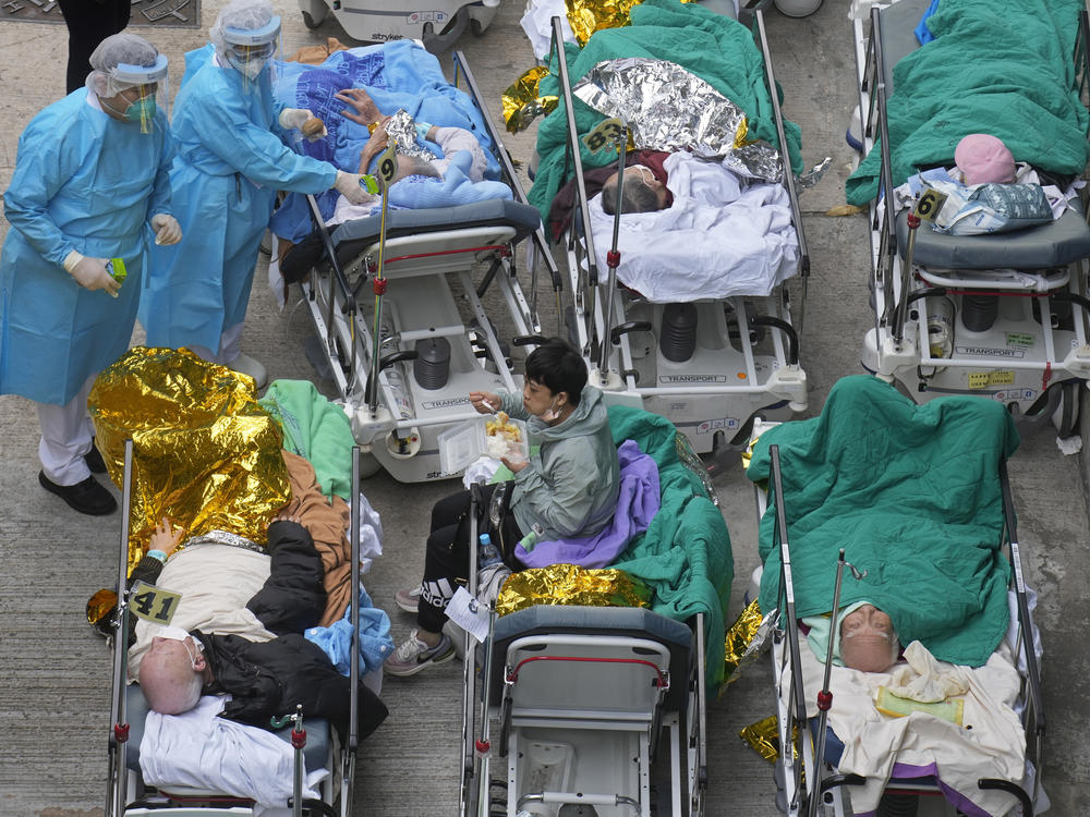 Patients are shown in hospital beds as they wait at a temporary holding area outside Caritas Medical Centre in Hong Kong on Wednesday.