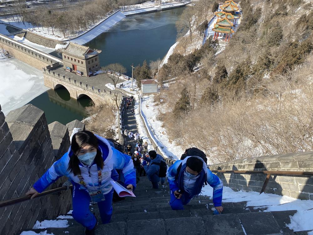 The small Olympic tour group travels up the Great Wall's steep steps.