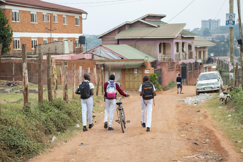 Joel Joseph, Kusemererwa Jonathan Henry and a friend walk home from school. Says Jonathan: 