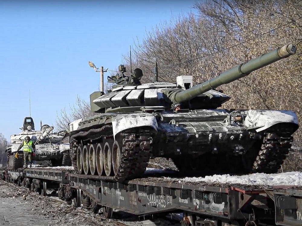 In this photo taken from video provided by the Russian Defense Ministry Press Service on Wednesday, Russian army tanks are loaded onto railway platforms to move back to their permanent base after drills in Russia.