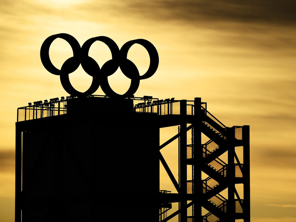 The Olympic Rings logo is seen on the top of a tower as the sun rises on Feb. 7, 2022 at the Beijing Winter Olympics.