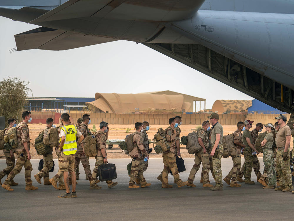 French soldiers who wrapped up a four-month tour of duty in the Sahel board a U.S. Air Force C-130 transport plane, leave their base in Gao, Mali on Wednesday, June 9, 2021.