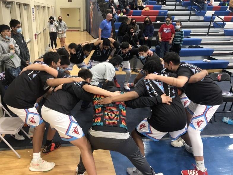 Wyoming Indian Boys basketball team huddle up before heading out to face the Greybull Buffalo.