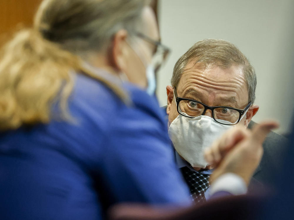 Greg McMichael, center, listens to his attorney during his 2021 state murder trial. McMichael, his son Travis McMichael, and neighbor William 