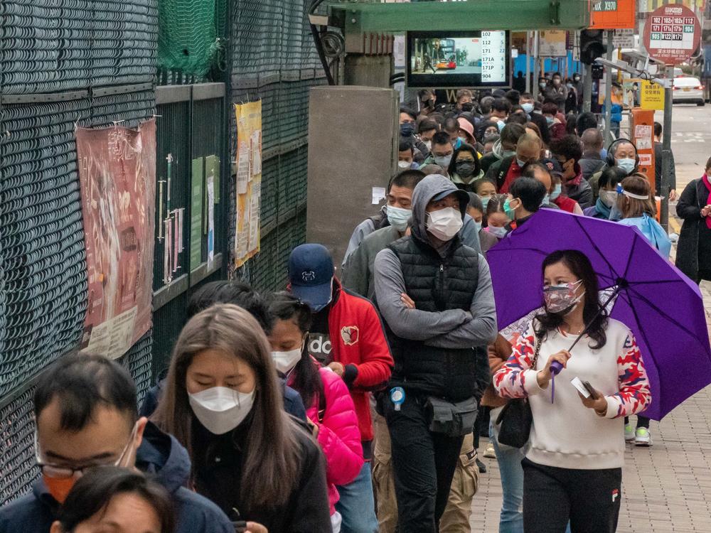 Residents wait in line at a makeshift COVID-19 testing station last week in Hong Kong. The Hong Kong government is rolling out citywide COVID-19 testing with support from mainland authorities.