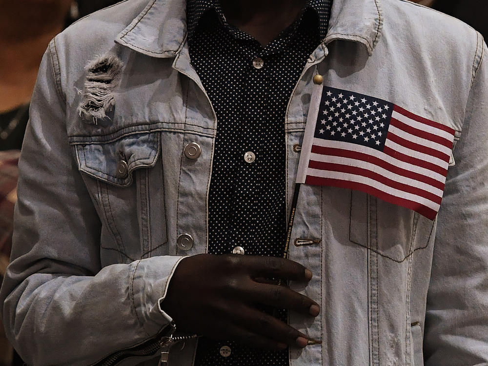 People pledge allegiance to America as they receive U.S. citizenship at a naturalization ceremony for immigrants in Los Angeles in 2017.