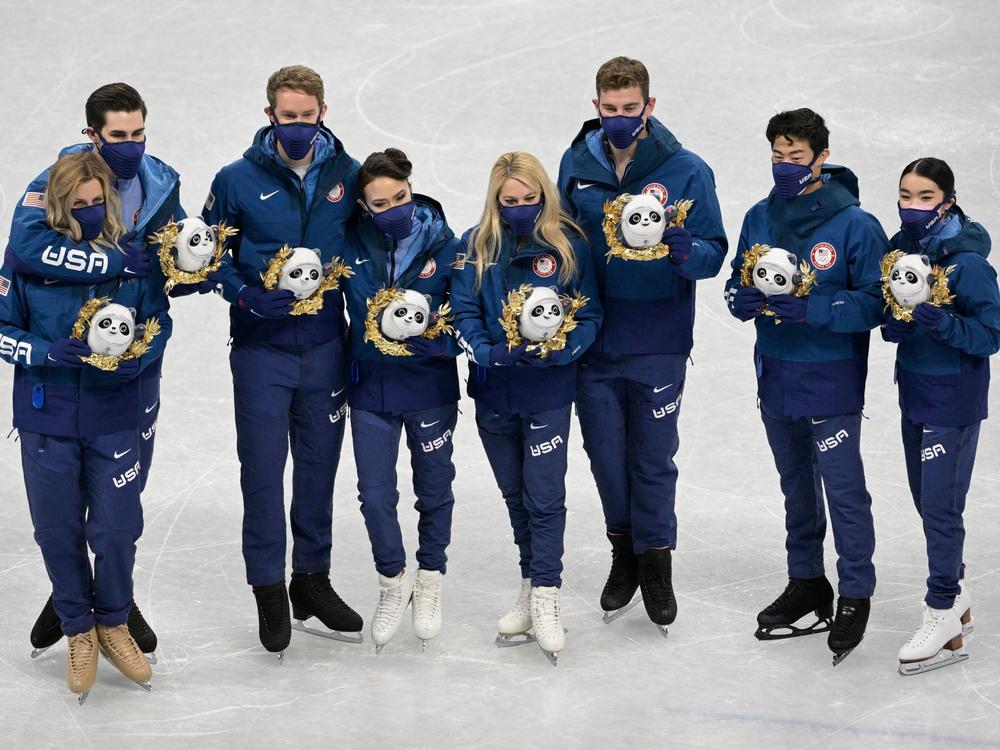 Team USA's silver medalists pose during the flower ceremony of the figure skating team event last week. They had asked to have the medal ceremony before they leave Beijing.