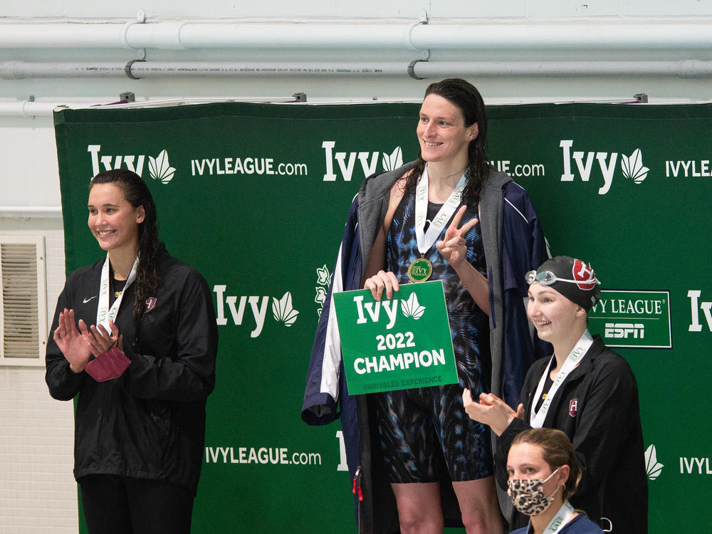 Lia Thomas, center, smiles on the podium after winning the 200-yard freestyle during the 2022 Ivy League Women's Swimming and Diving Championships on Friday.
