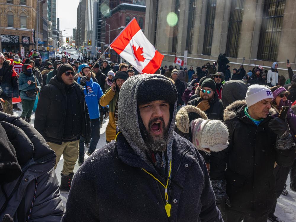 People participate in a protest organized by truck drivers opposing vaccine mandates on Wellington St. on Saturday in Ottawa, Ontario.