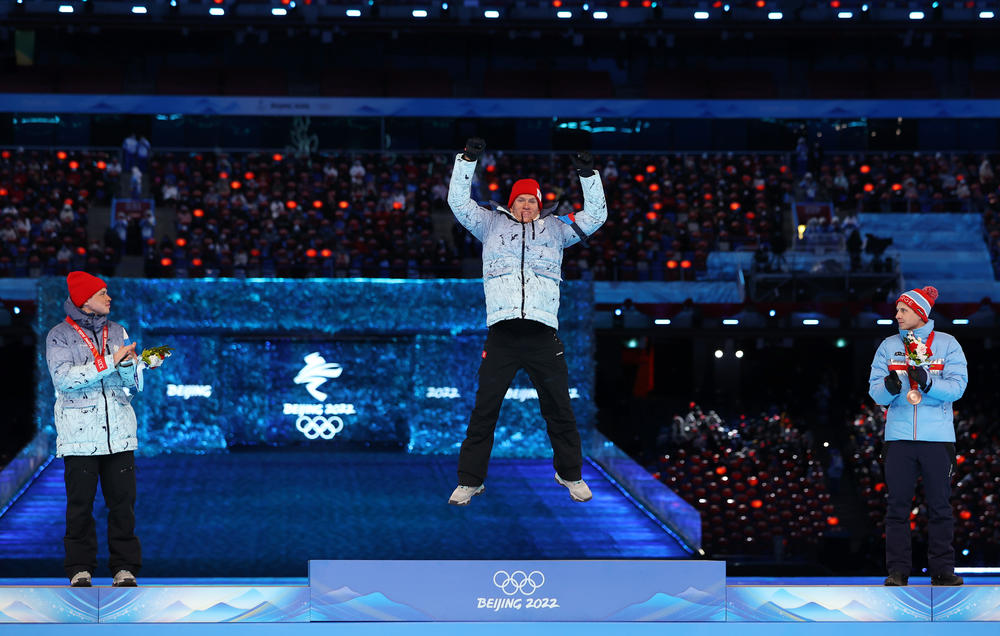 Gold medallist Alexander Bolshunov of Team ROC, center, Silver medallist Ivan Yakimushkin of Team ROC, left, and Bronze medallist Simen Hegstad Krueger of Team Norway, right pose with their medals during the Men's Cross-Country Skiing 50km Mass Start Free medal ceremony during the Beijing 2022 Winter Olympics Closing Ceremony.