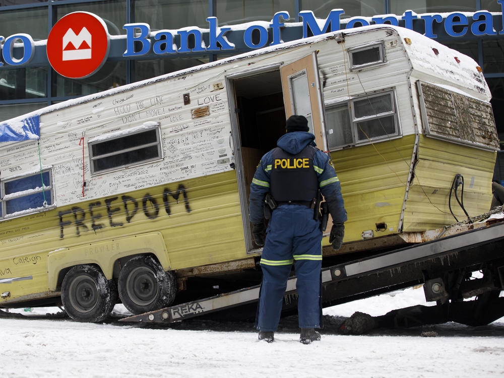 A camper is towed away by authorities clearing a trucker protest that was aimed at COVID-19 measures in Ottawa on Sunday.