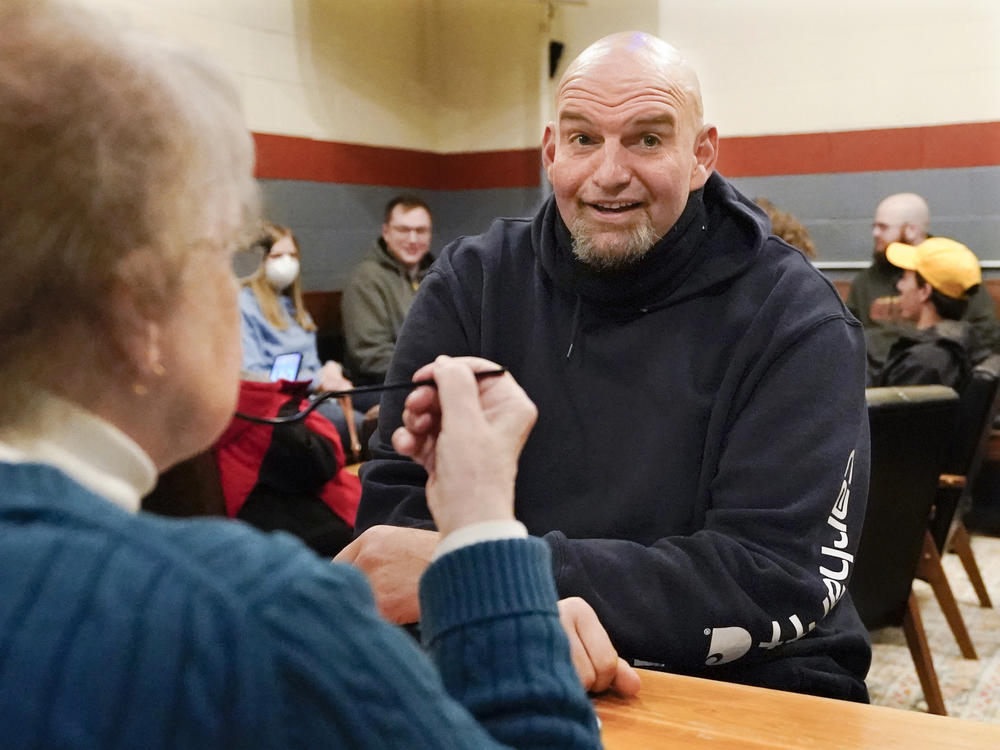 Pennsylvania Lt. Gov. John Fetterman, who's considered the early front-runner in the Democratic primary for the state's open U.S. Senate seat, talks with a voter during a campaign stop at the Mechanistic Brewery, in Clarion, Pa., on Feb. 12.