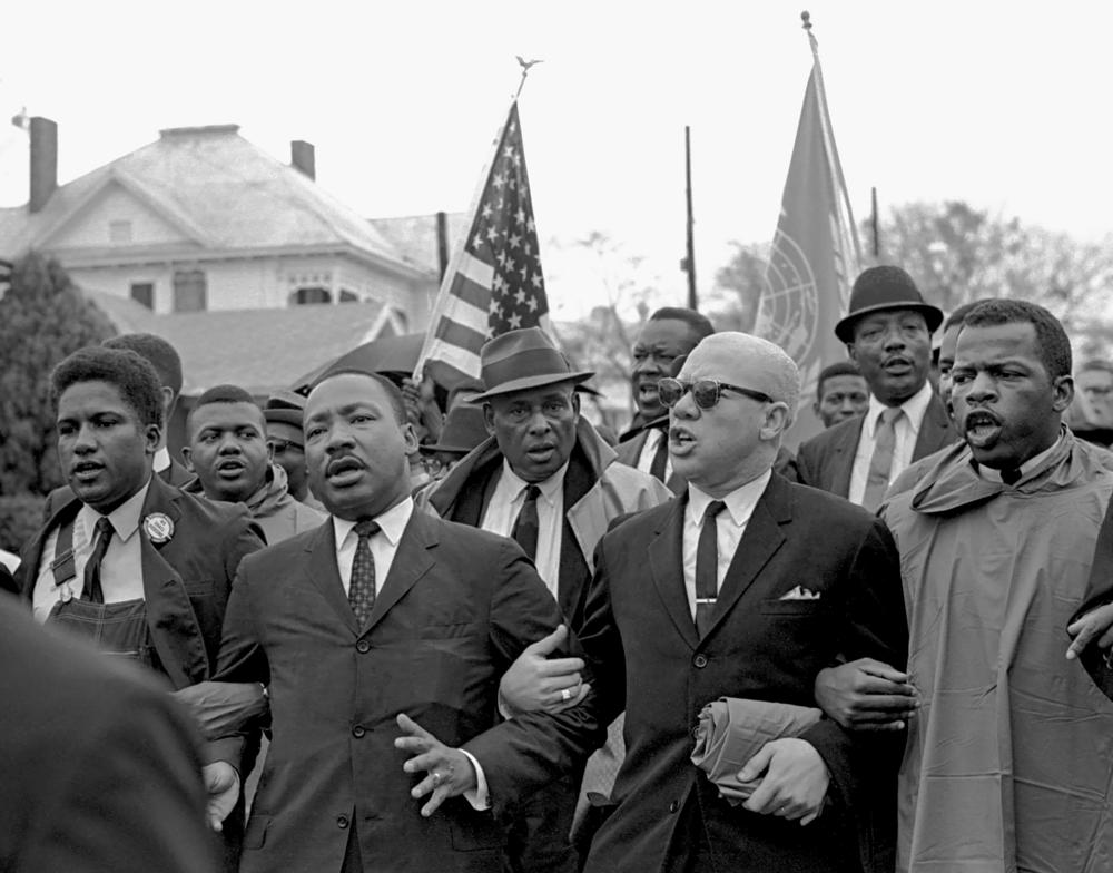 Martin Luther King Jr. links arms with fellow Selma to Montgomery marchers in 1965.