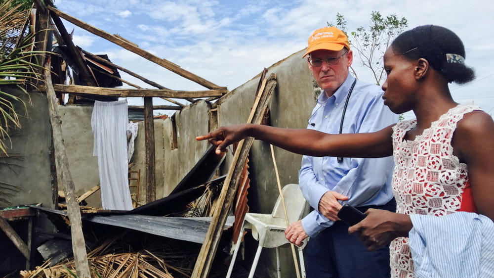 Farmer, co-founder of Partners in Health, stands with Mirlande Estenale in front of what used to be her home in Les Cayes, Haiti. He visited Haiti, a country where his group has worked to improve health care, in the aftermath of Hurricane Matthew in 2016.