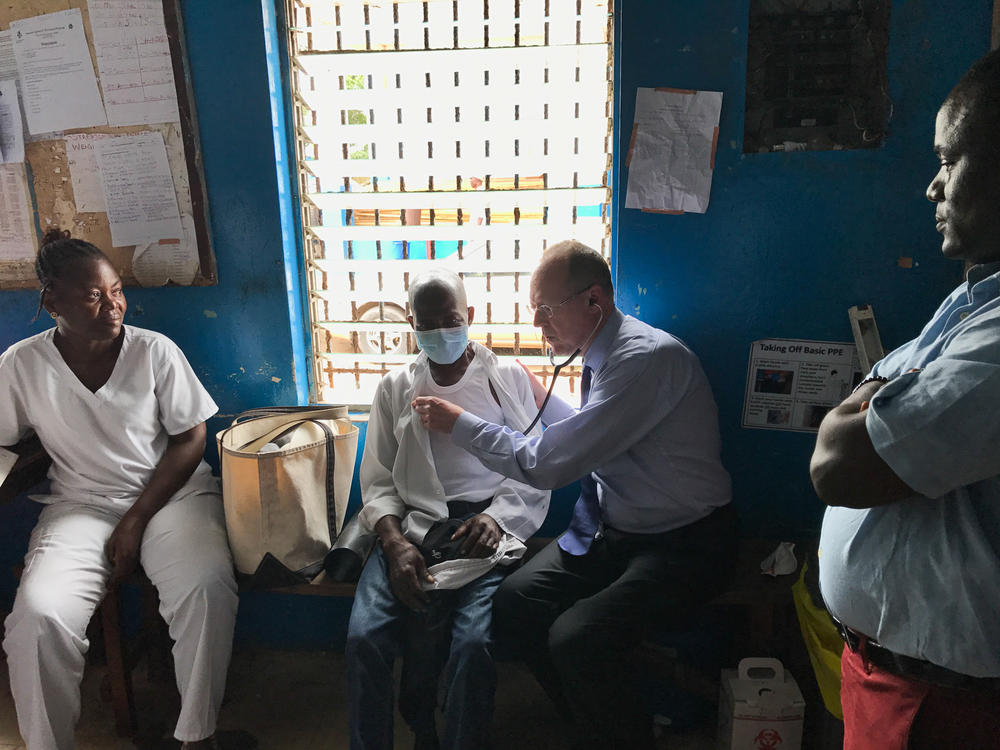 Farmer examines a tuberculosis patient in Monrovia, Liberia.