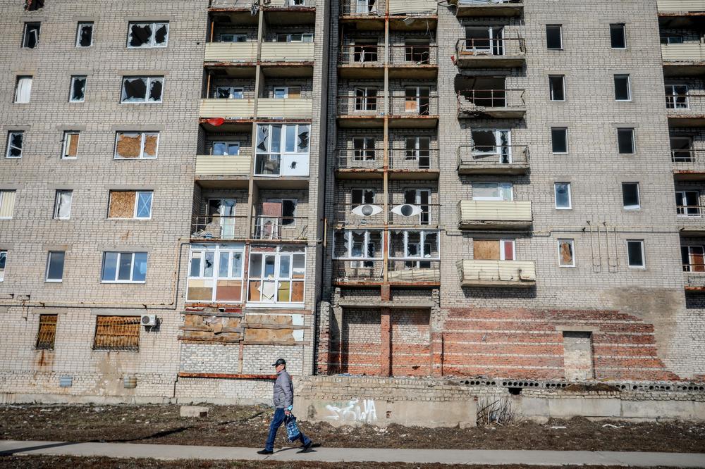 A man walks past an abandoned building in the Donetsk region town of Avdiivka on Monday.