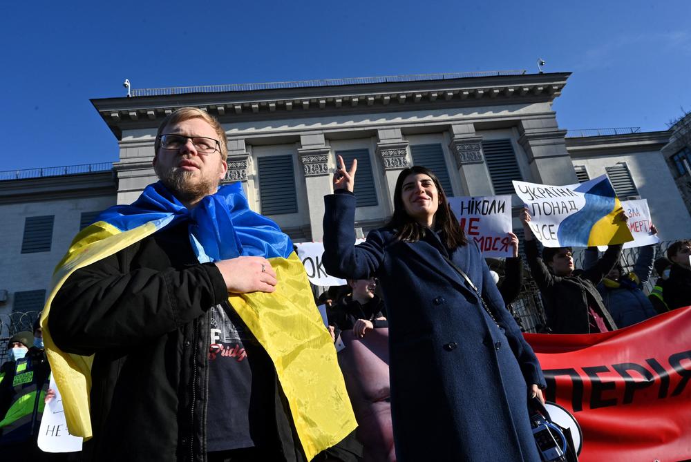 Activists hold banners and shout slogans during an 