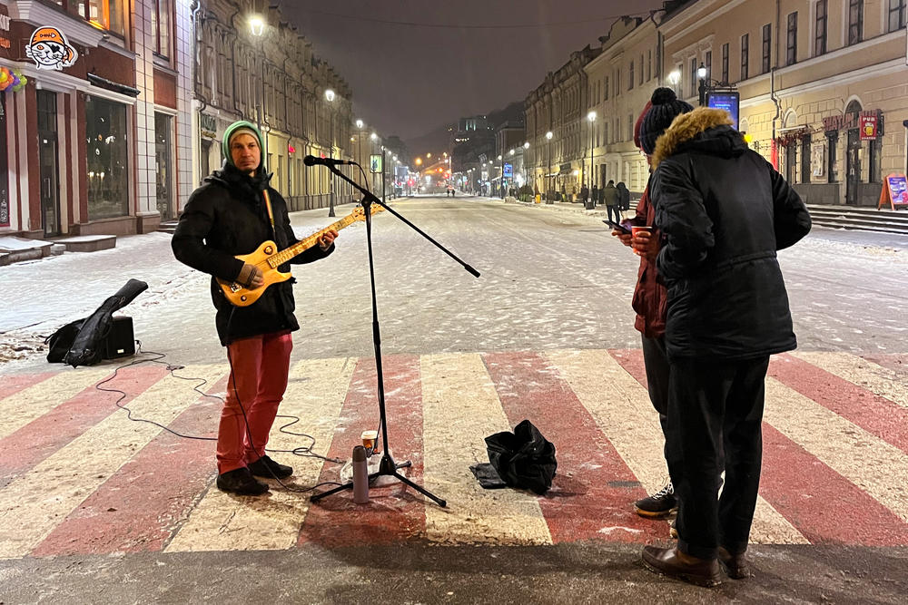 Guitarist Vitaly Abramov (left) plays for tips in downtown Kyiv. He sings in both Russian and Ukrainian.