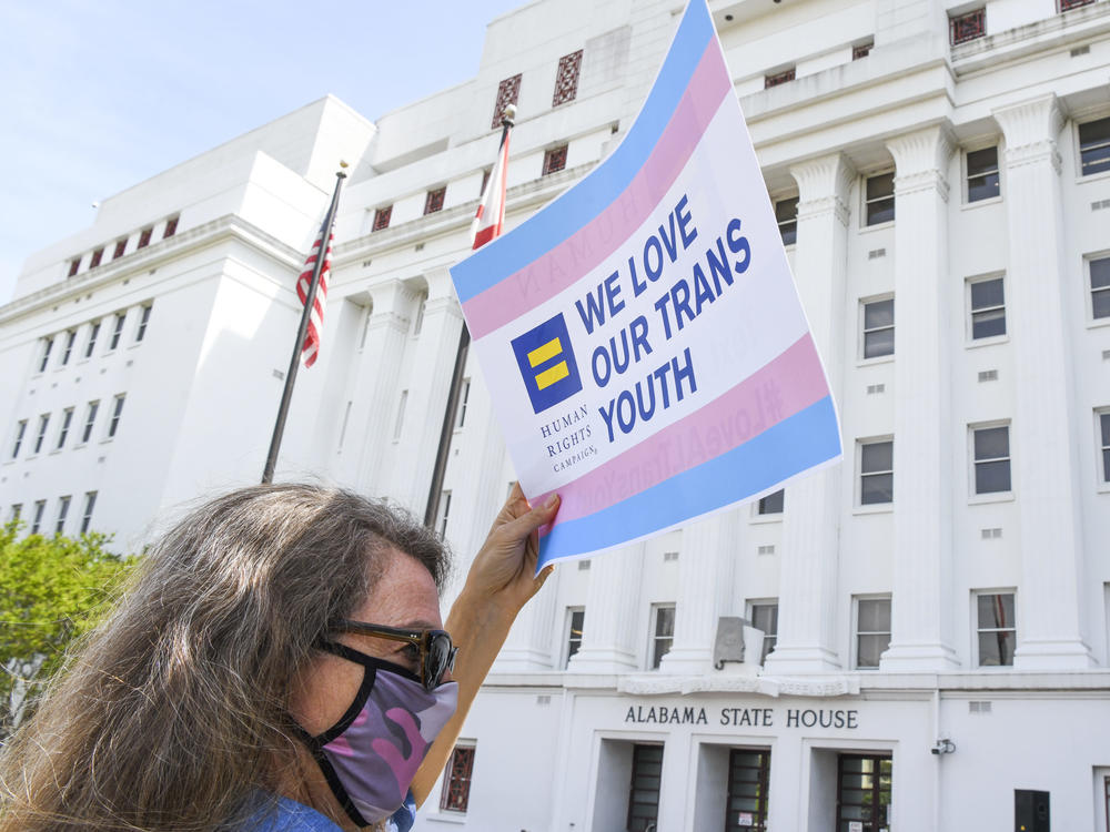Jodi Womack holds a sign that reads 