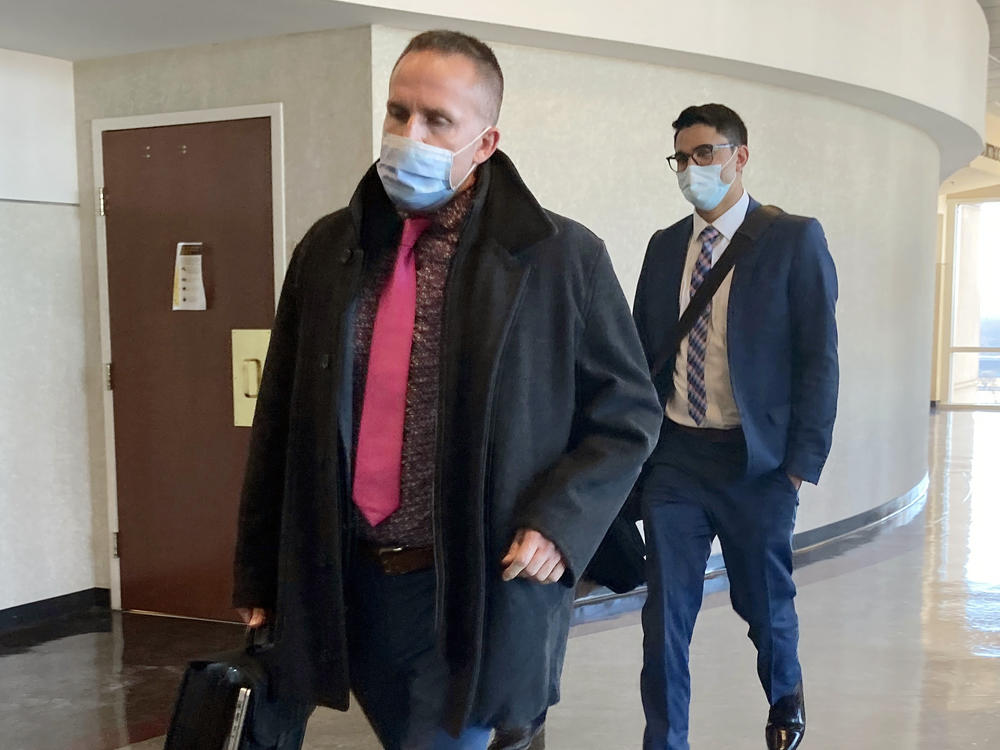 Brett Hankison (left) exits the courtroom after the first day of jury selection in his trial on Feb. 8, in Louisville, Ky. Hankison is on trial for allegedly firing shots into the apartment next door to Breonna Taylor's the night she was killed.