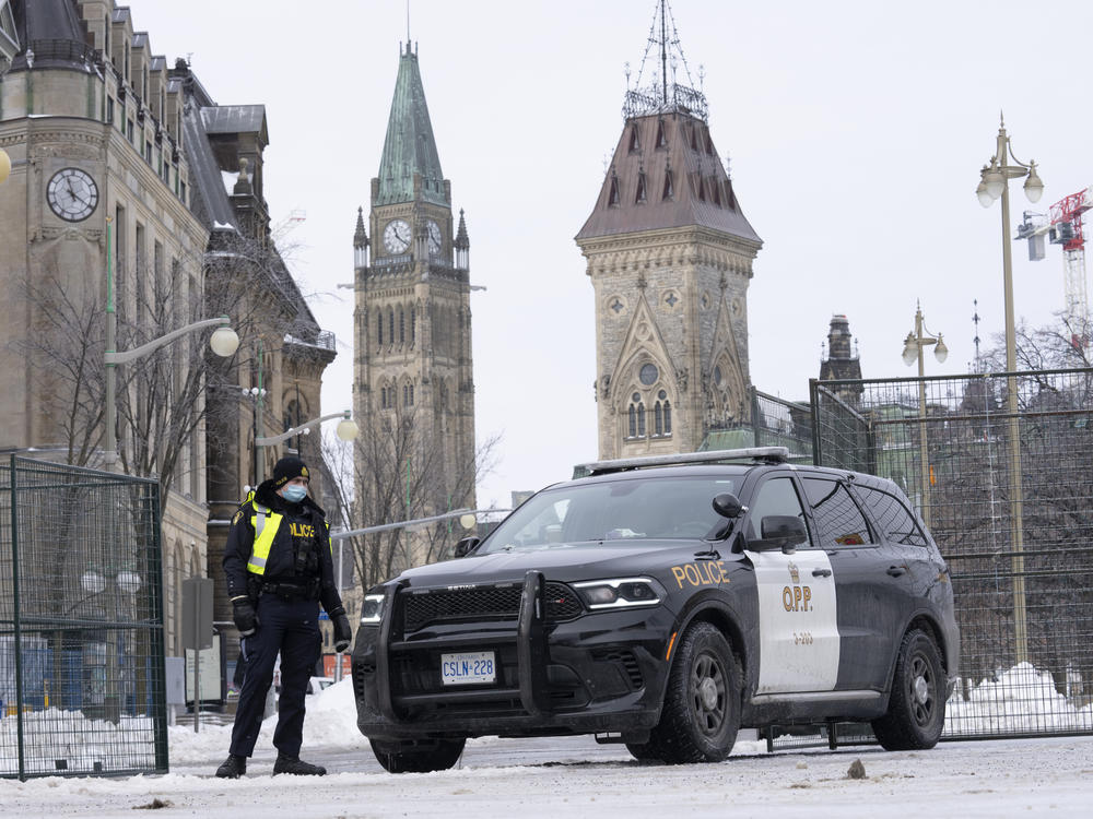 A police officer mans a checkpoint near Parliament Hill on Wednesday in Ottawa. Ottawa protesters who vowed never to give up are largely gone, chased away by police in riot gear in what was the biggest police operation in the nation's history.