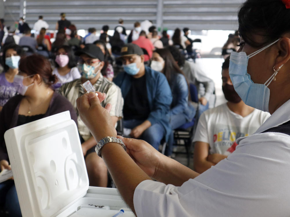 A health worker in Mexico City prepares a Sputnik V dose during a mass vaccination effort against COVID-19. A new study in Mexico shows that non-mRNA vaccines like the Russian version can be as effective as mRNA vaccines like Pfizer if the patient has previously been infected with SARS-CoV-2.