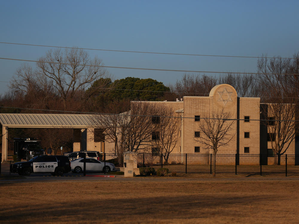 A police vehicle sits in front of Congregation Beth Israel in Colleyville, Texas, on Jan. 16, the day after a gunman took worshippers hostage at the synagogue. Colleyville is among dozens of U.S. cities dealing with the distribution of antisemitic flyers in recent weeks.