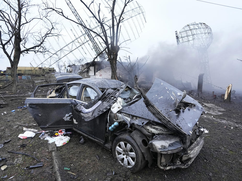 Damaged radar, a vehicle and equipment are seen at a Ukrainian military facility outside Mariupol.