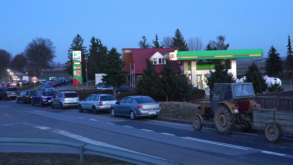 People wait for gas at the station near Ukraine's border with Poland after Russian President Vladimir Putin authorized a military operation in Ukraine.