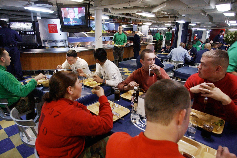 Sailors about the aircraft carrier U.S.S. Nimitz watching President George W. Bush's 2003 State of the Union speech. Not long afterwards, Bush launched an invasion of Iraq.