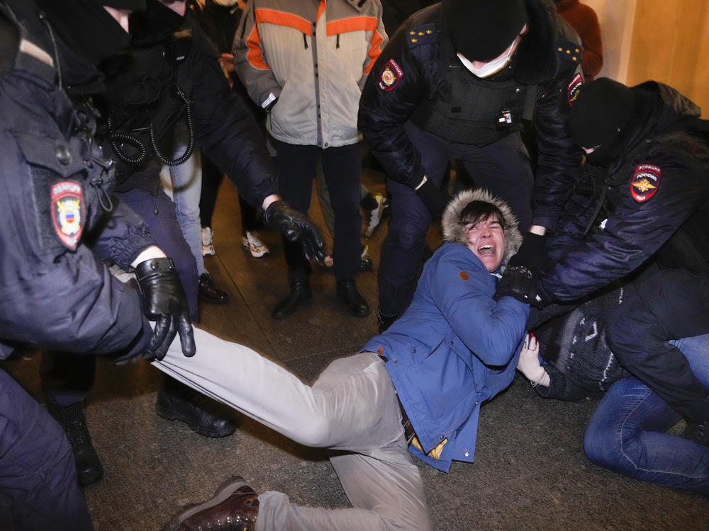 Police officers detain demonstrators in St. Petersburg, Russia, Thursday. Hundreds of people gathered in Moscow and St.Petersburg to protest against Russia's attack on Ukraine.