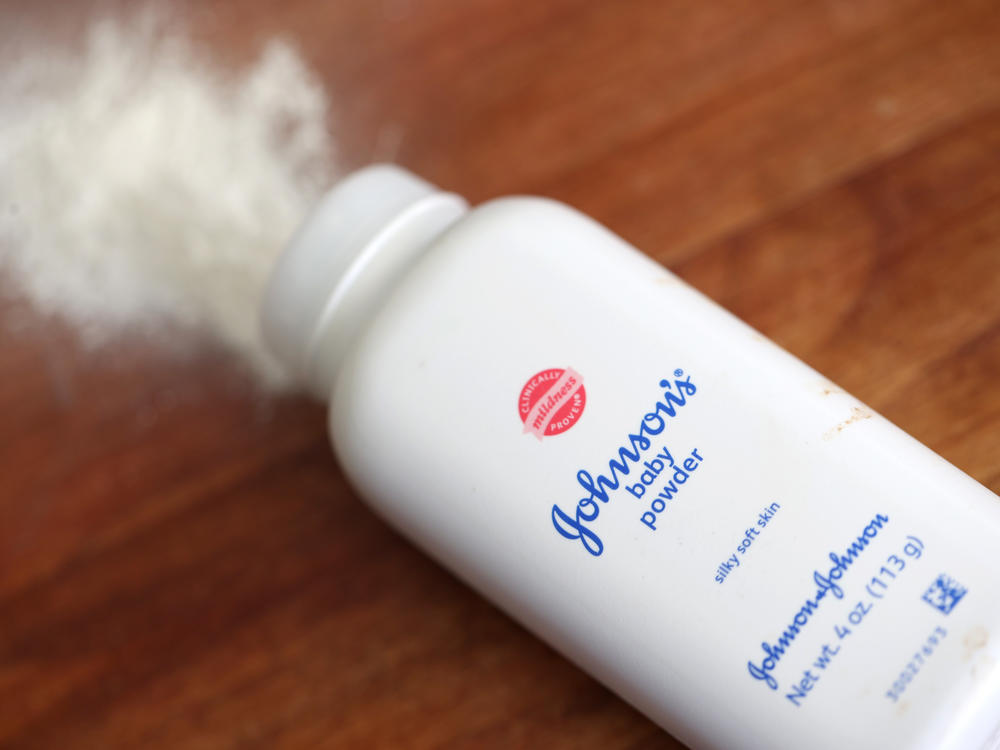 Johnson & Johnson's baby powder is displayed on a table in this photo illustration. A federal judge has allowed Johnson & Johnson's spinoff of a unit to proceed with a controversial bankruptcy.