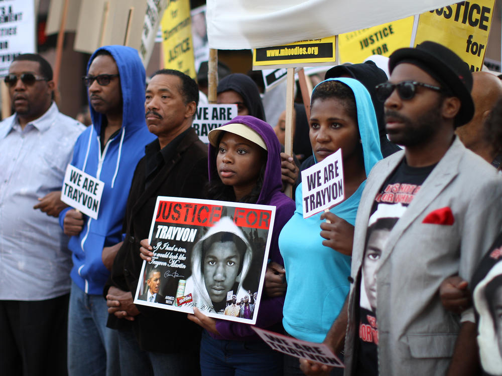 People in Los Angeles walk in a silent protest march on April 9, 2012, to demand justice for the killing of Trayvon Martin.