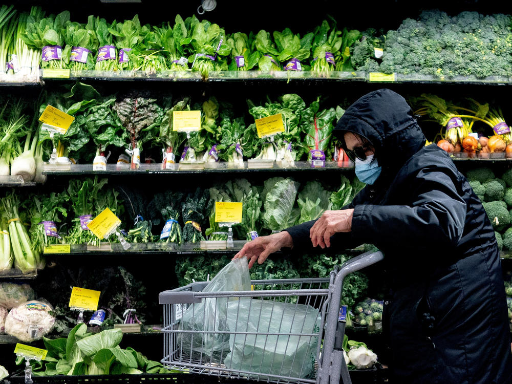 A shopper in Washington, D.C., wears a mask at a grocery store earlier this month but won't have to in a few days. Mayor Muriel Bowser announced that she will let DC's mask mandate expire.