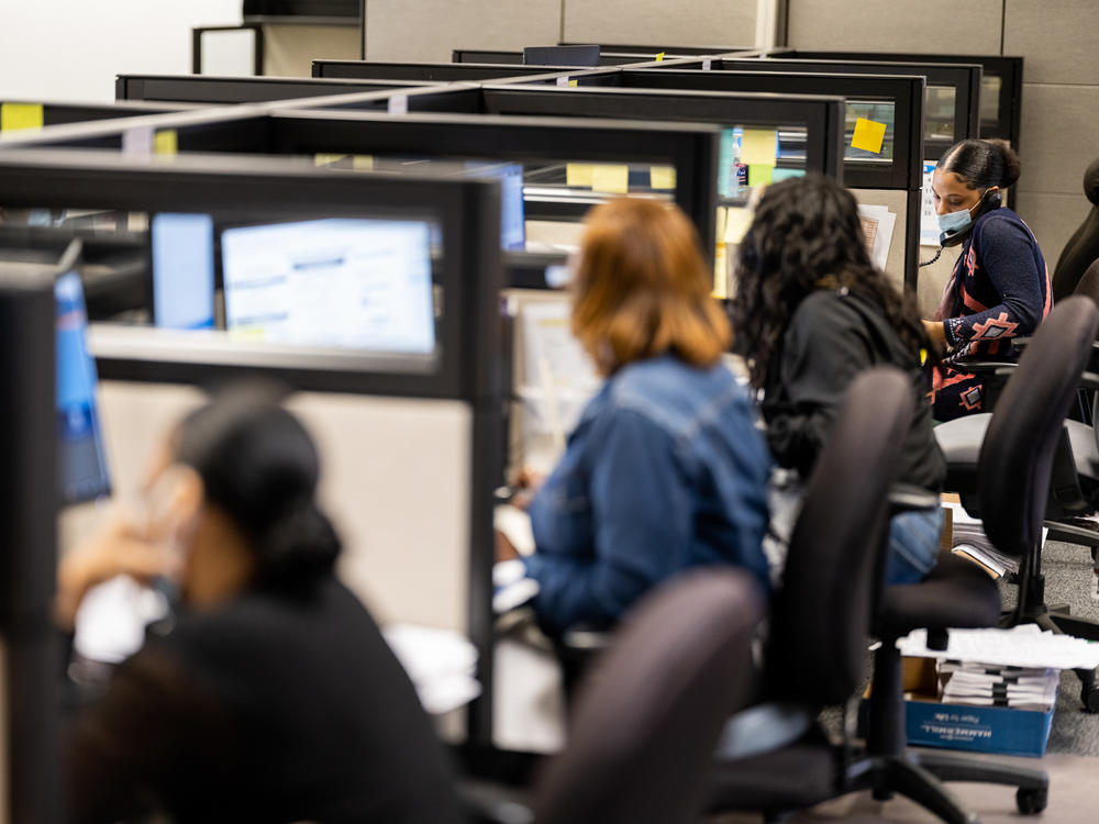 Workers answer questions in the call center at the Harris County Elections Office in Houston. In Harris County, 40% of mail-in ballot applications were flagged for rejection.