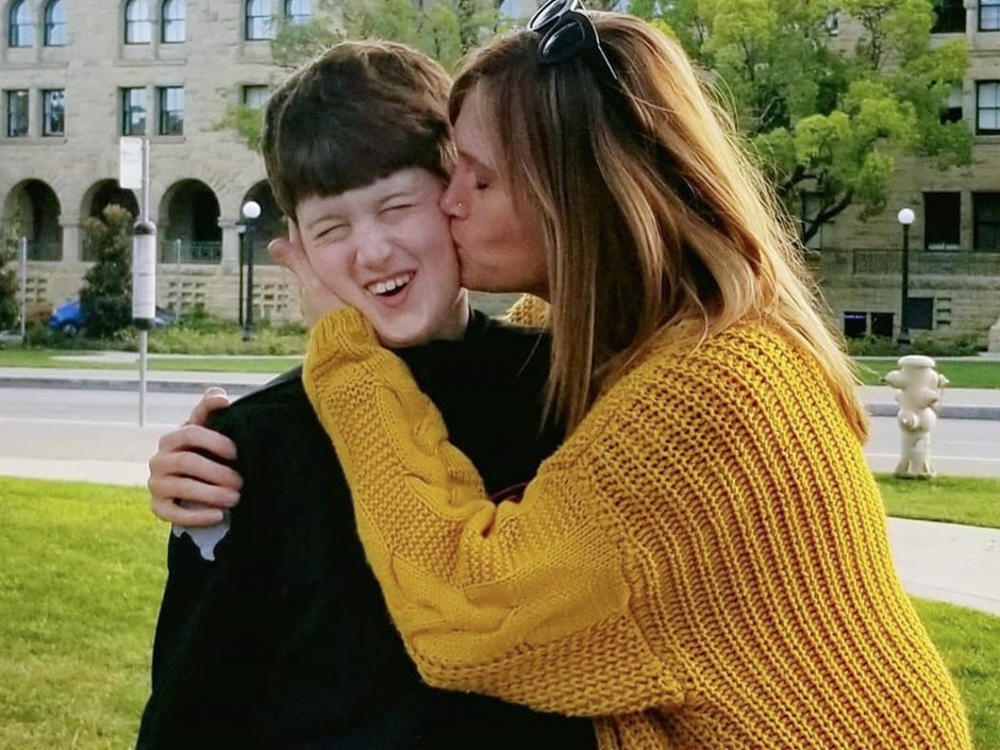 Texas resident Amber Briggle kisses her son. She says the onslaught of anti-trans legislation in the state is emotionally traumatizing.