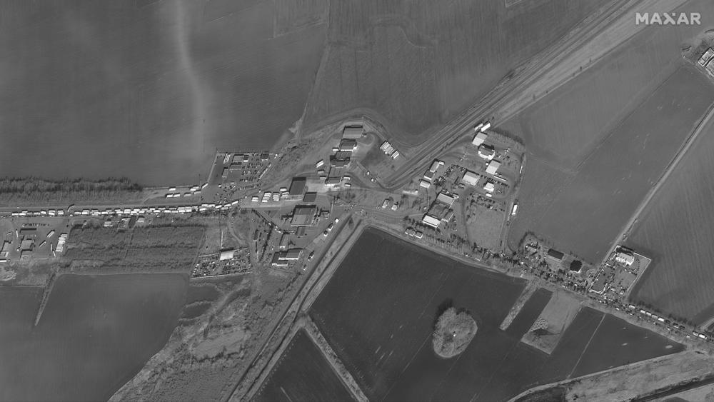 Satellite images show a 4-mile-long traffic jam of people, cars and trucks trying to leave Ukraine and cross into Romania on Friday near the Siret border crossing.