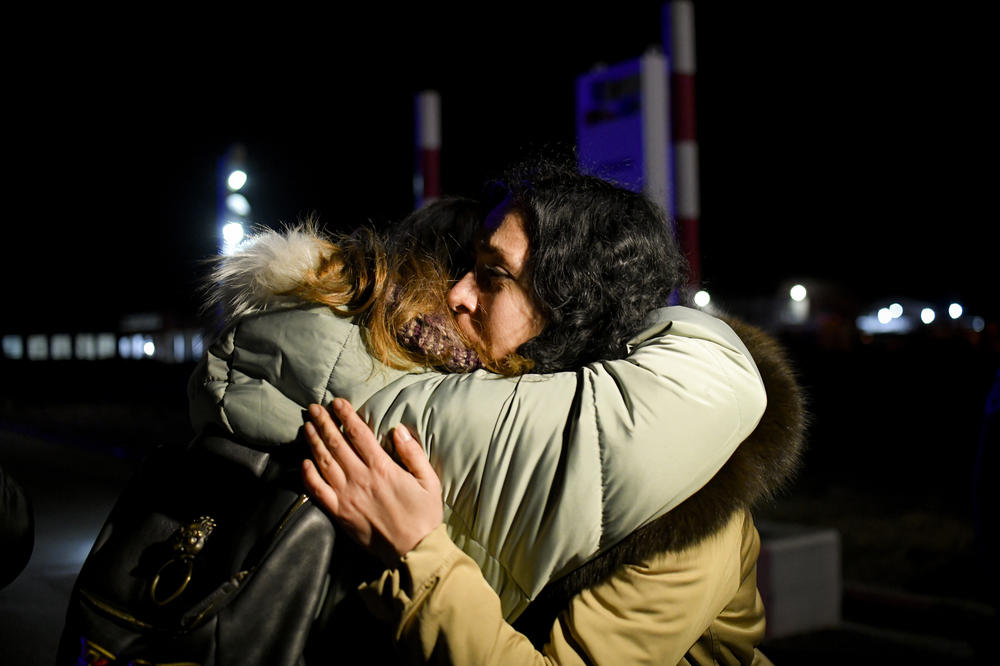 Sisters embrace after crossing the border from Ukraine in Siret, Romania, on Friday.